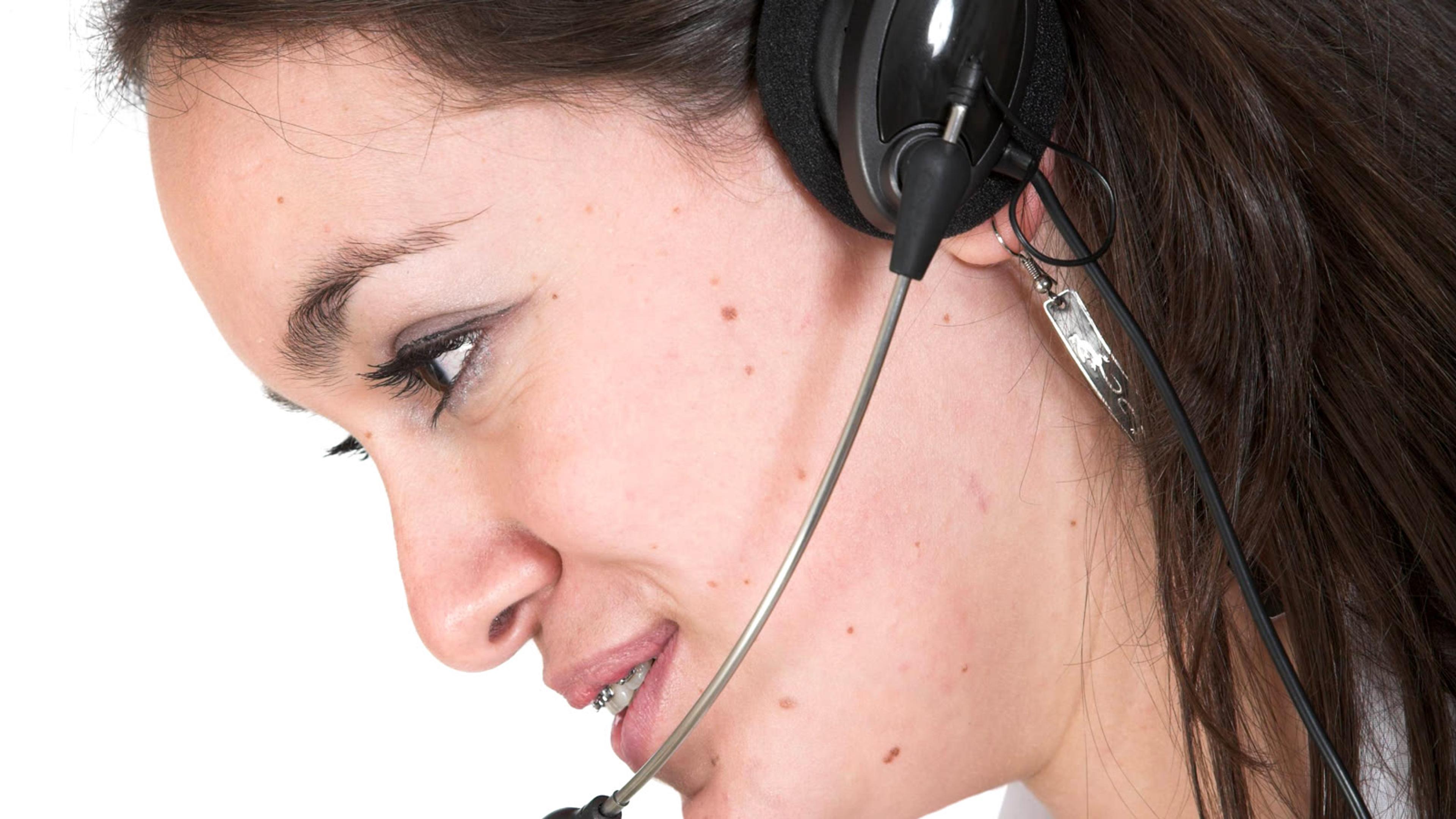Customer service representative wearing a headset taking an internal call