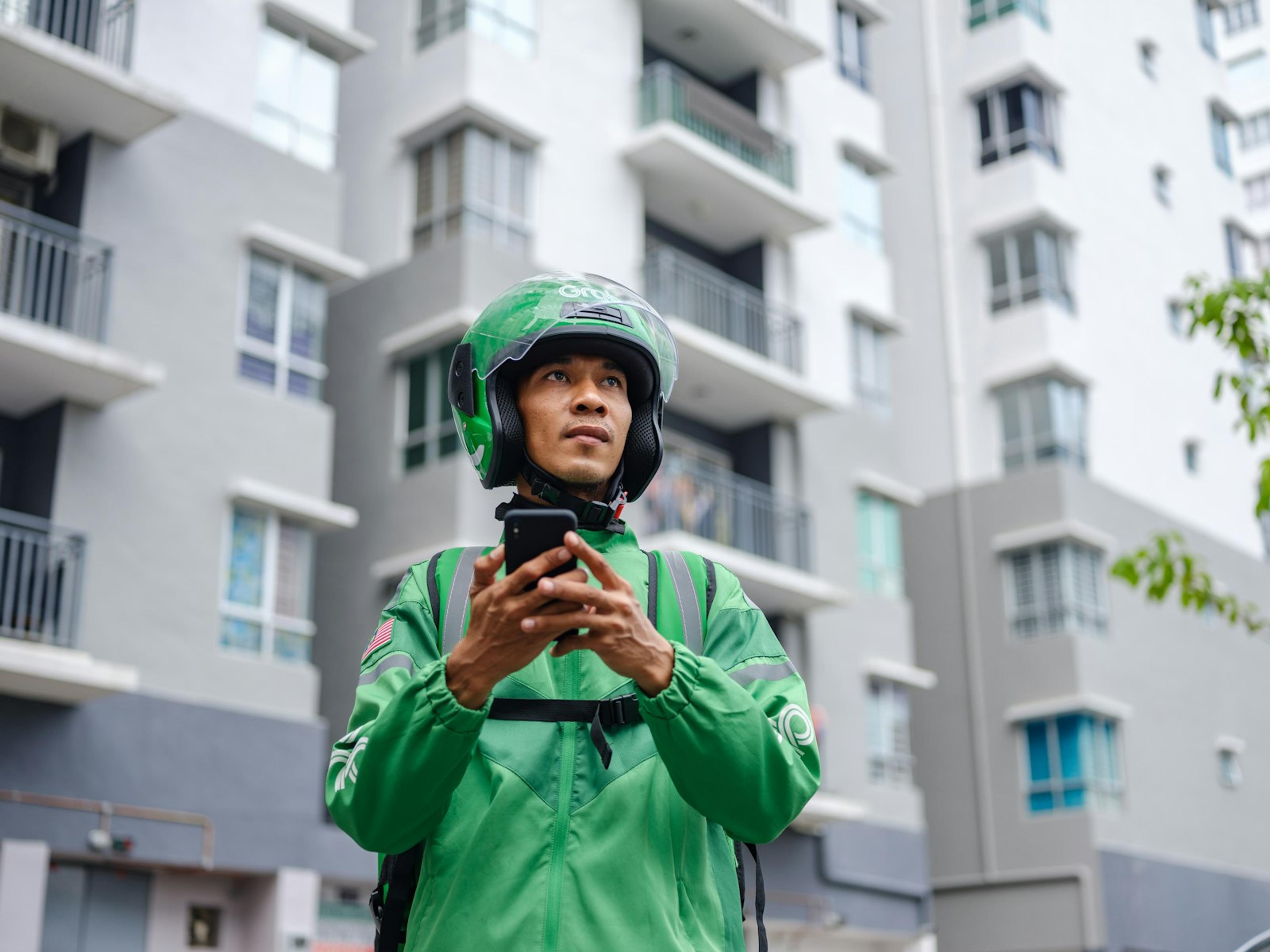 Delivery worker using a smartphone for mobile business communication