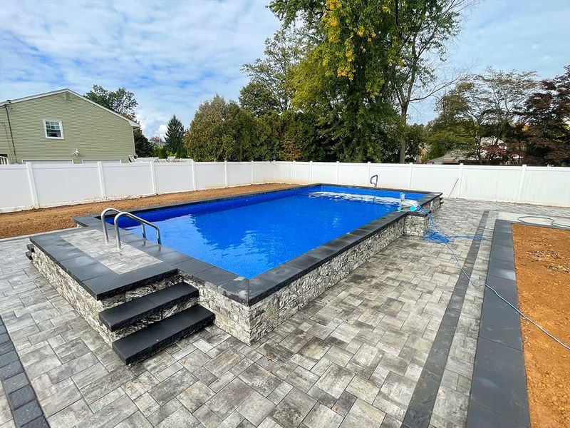 Raised pool with paver surround