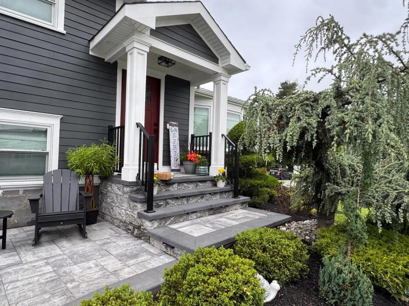 Covered front entry, stone veneer steps, paver walkway