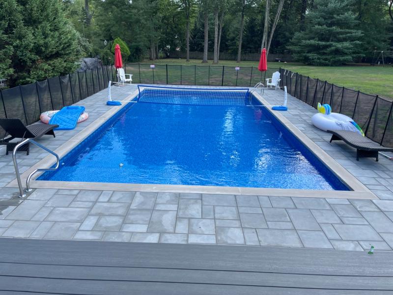 Full-width bench steps, pergola deck, gray paver surround
