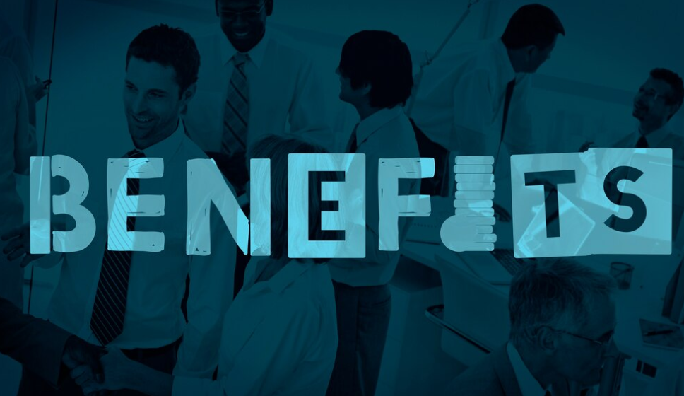 The word "benefits" over a team working together in an office
