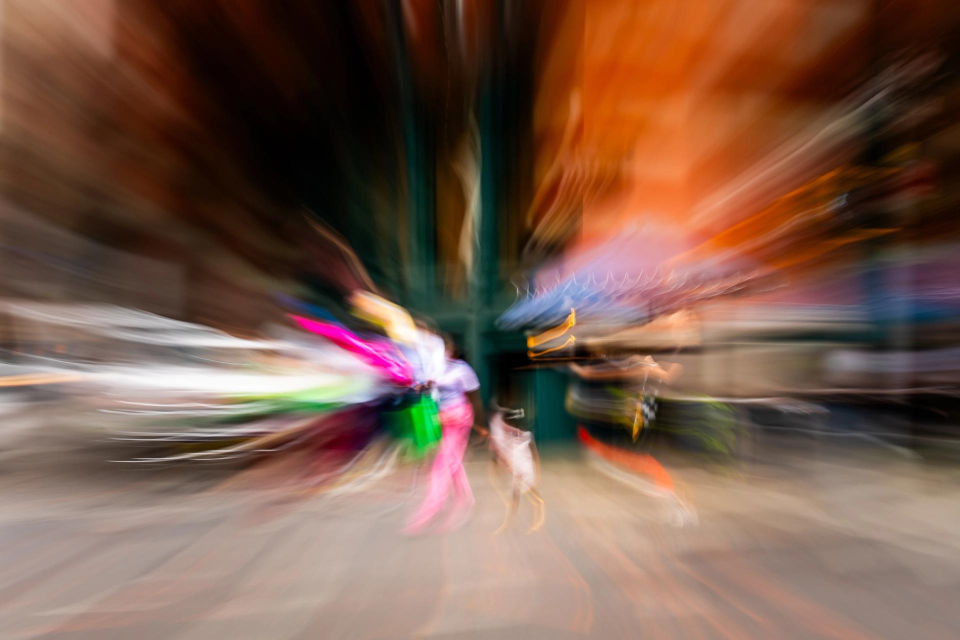 Zoom burst during a slow exposure, the scene exploding outward from the center in streaks of color