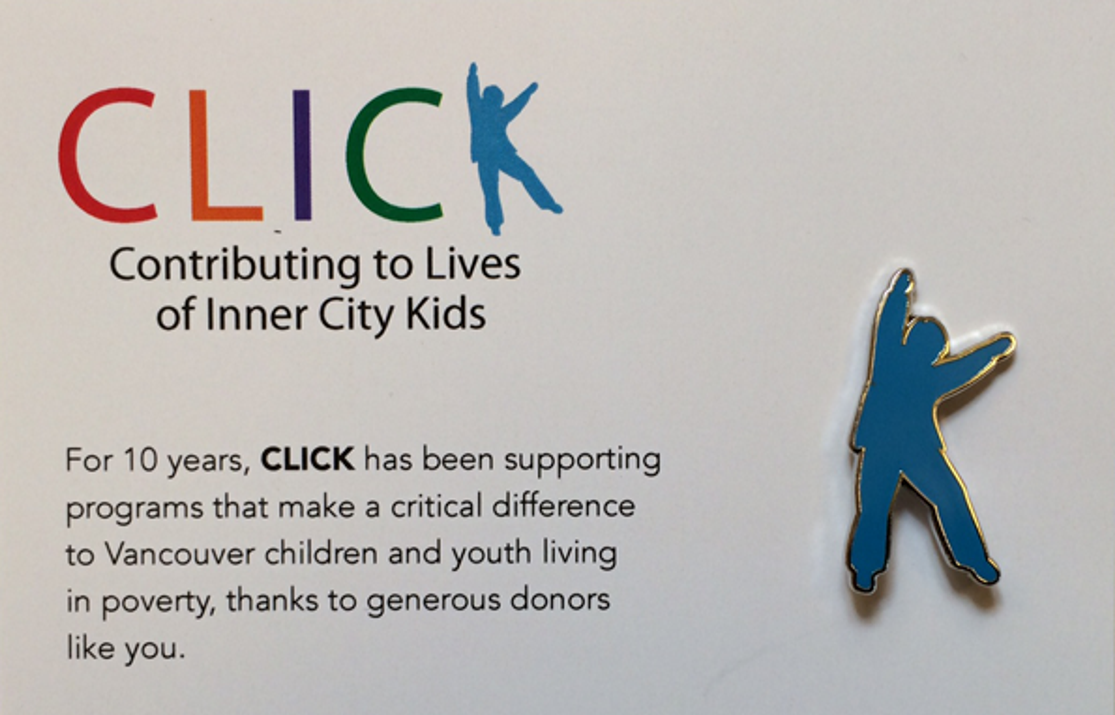 The blue enamel Blue Boy lapel pin beside the CLICK logo