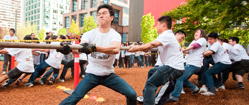 Students and Vancouver Police officers pulling on the tug of war rope outside the Vancouver Art Gallery