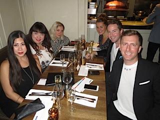 Five guests raising their glasses at CLICK's Dinner to Make a Difference at Café Medina