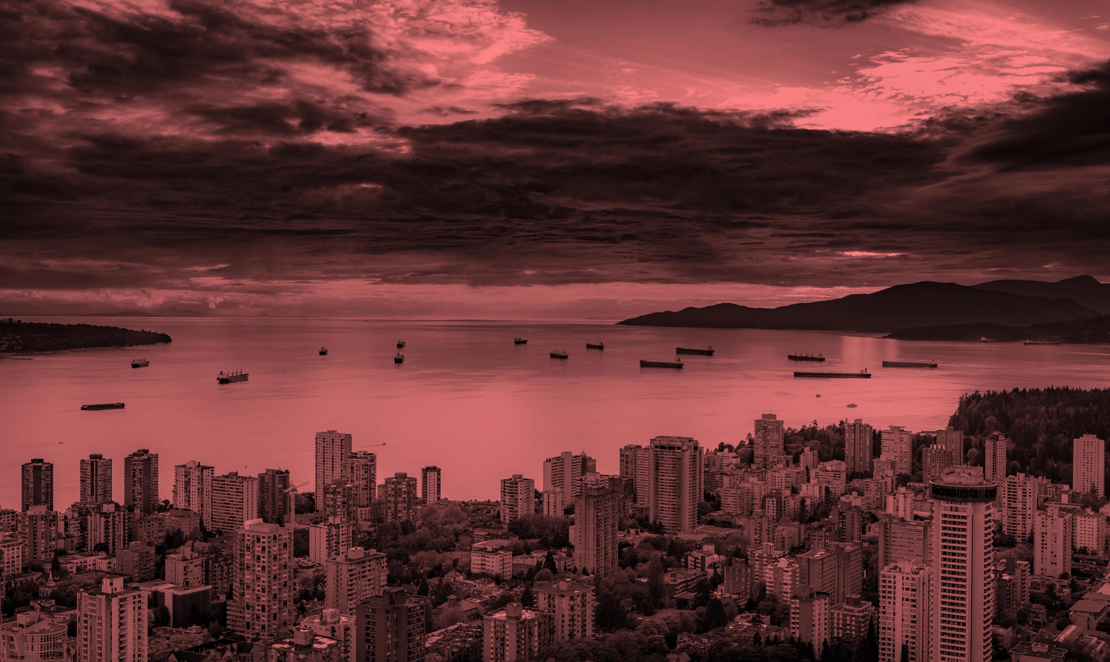 Vancouver harbour and skyline at dusk under a red sky