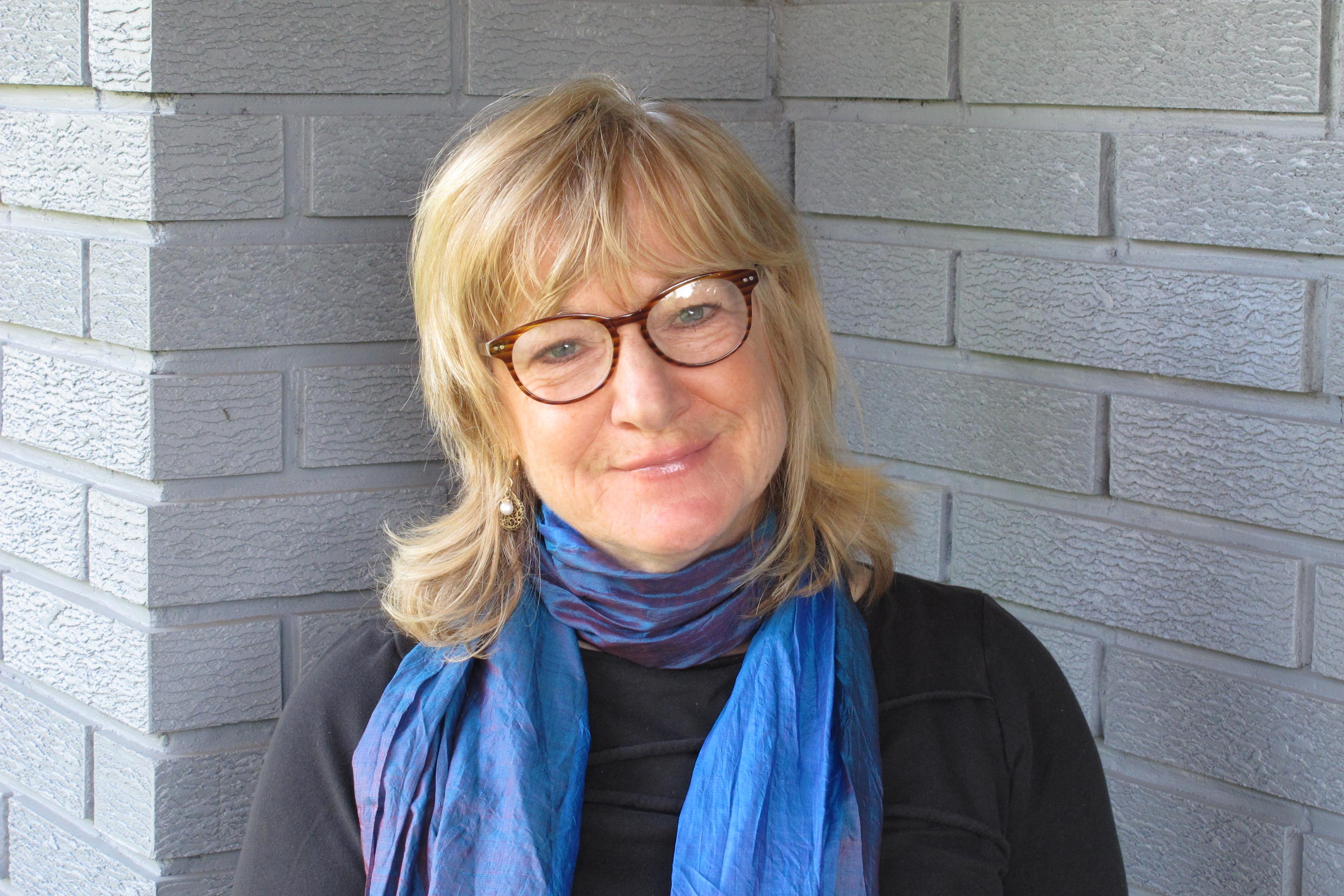 Portrait of CLICK president Catherine Atyeo outside a brick building