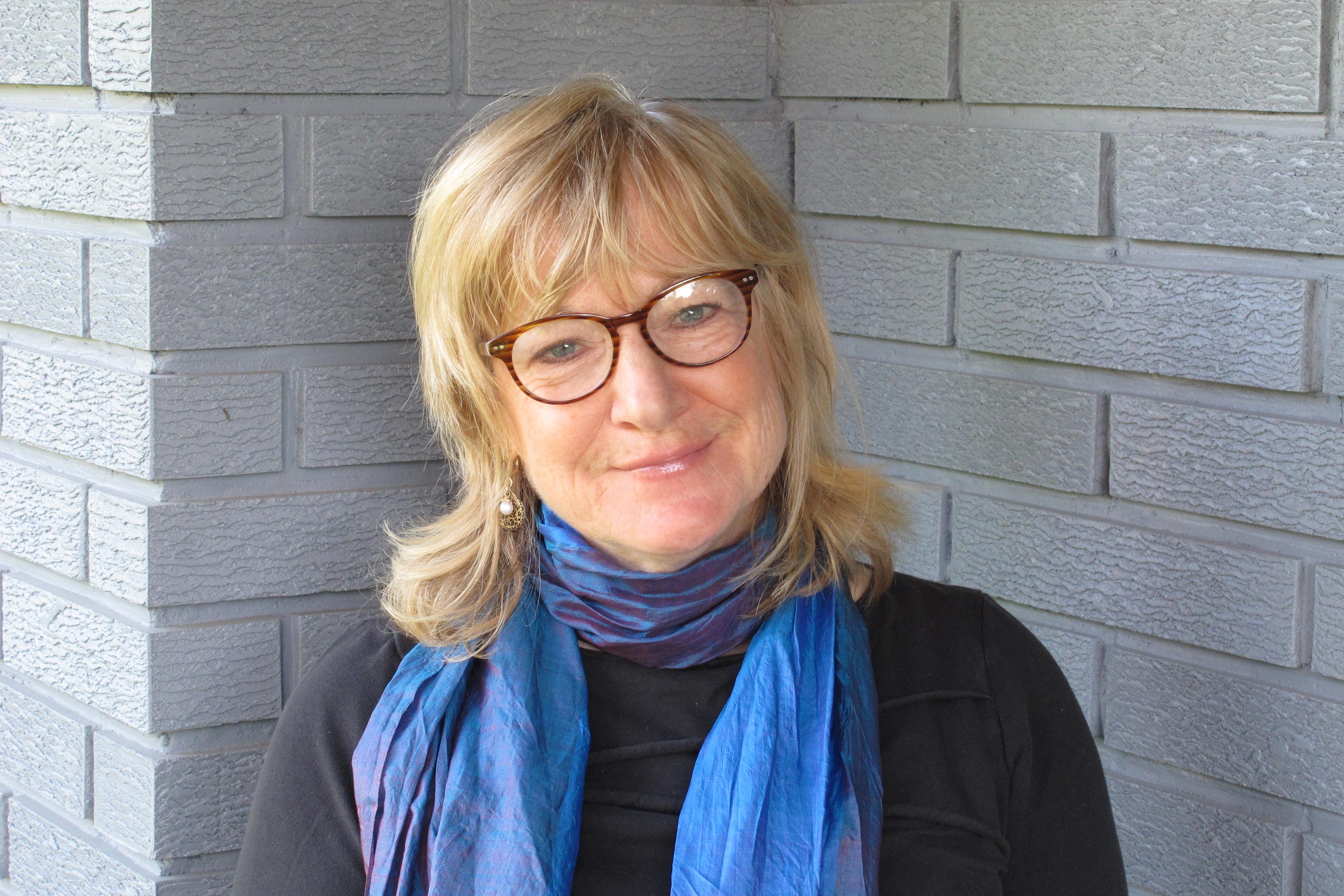 Portrait of CLICK president Catherine Atyeo outside a brick building