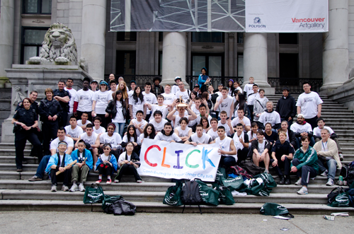 Students and volunteers fill the steps of the Vancouver Art Gallery behind a hand-lettered CLICK banner