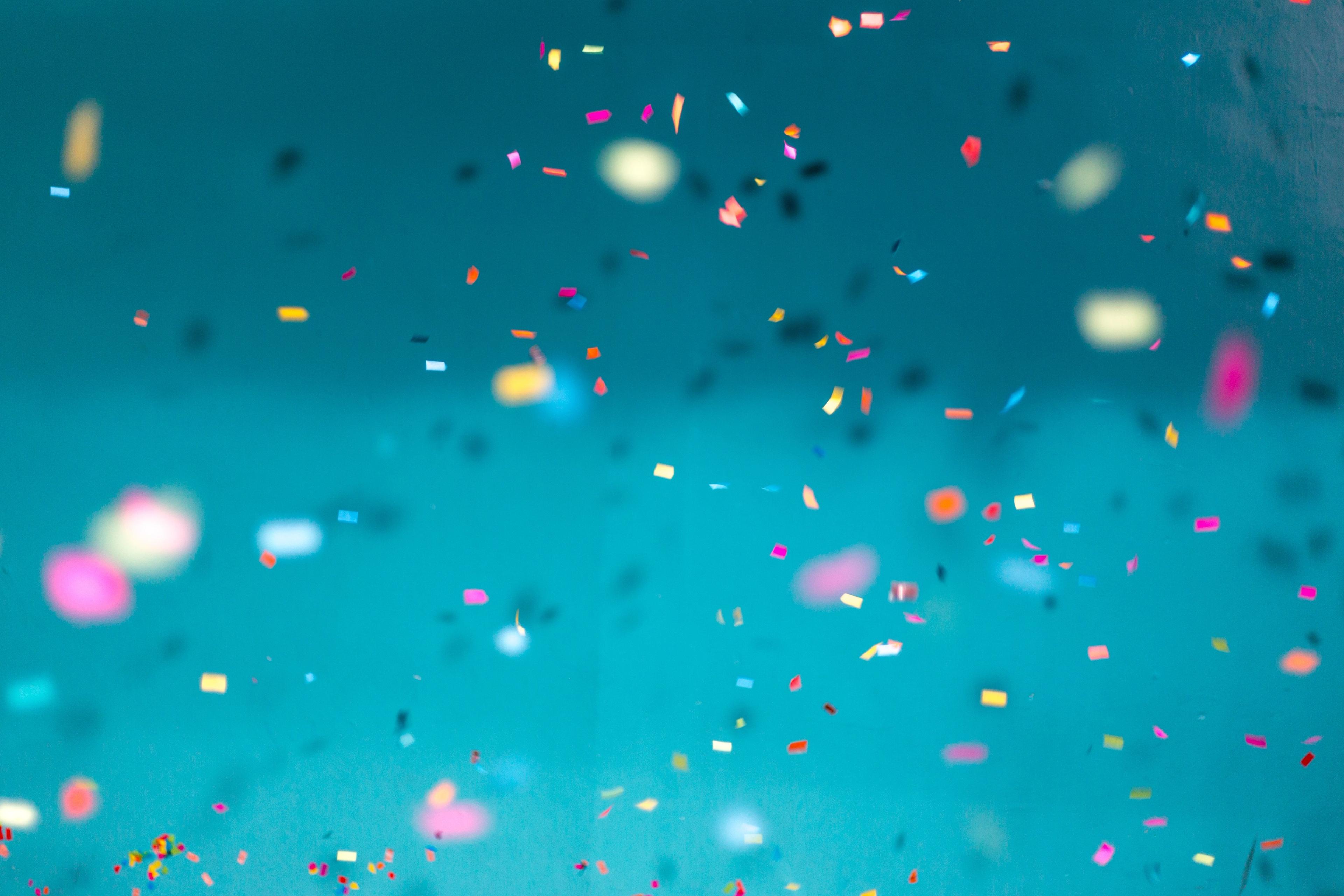 Confetti falling against a blue background