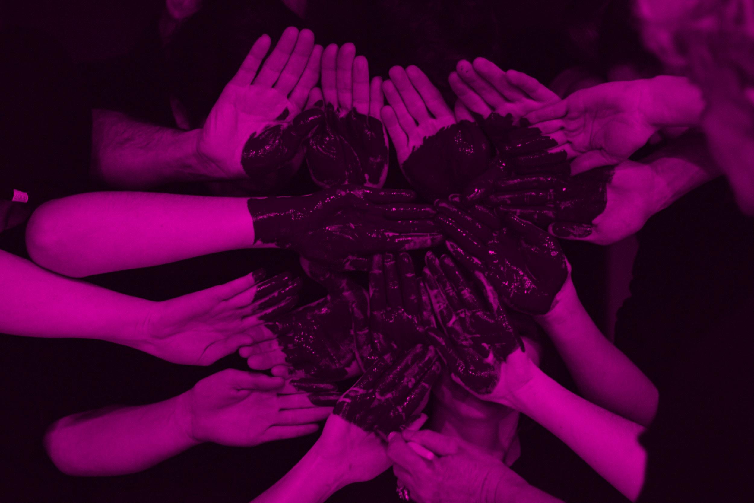 Many hands arranged into the shape of a heart