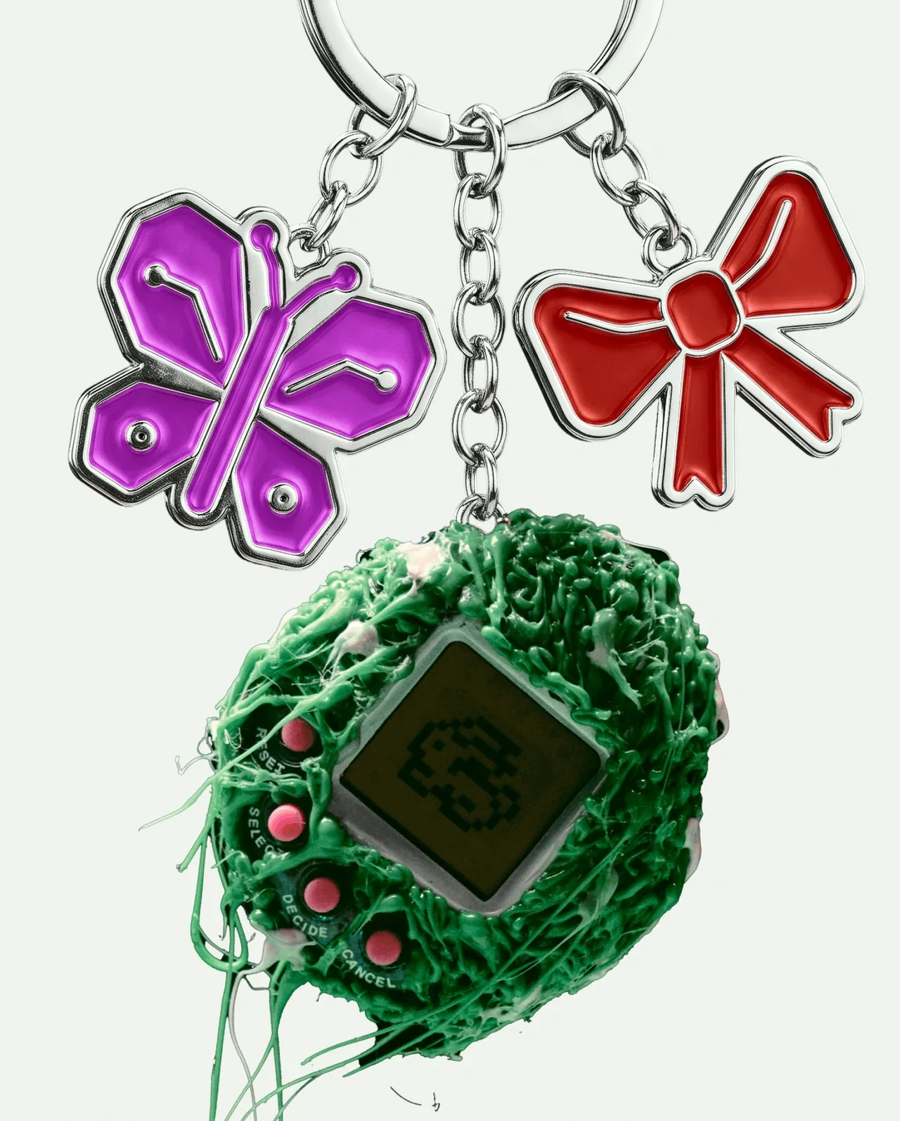 A keyring of purple butterfly and red bow charms with a green strand-covered pixel-screen gadget
