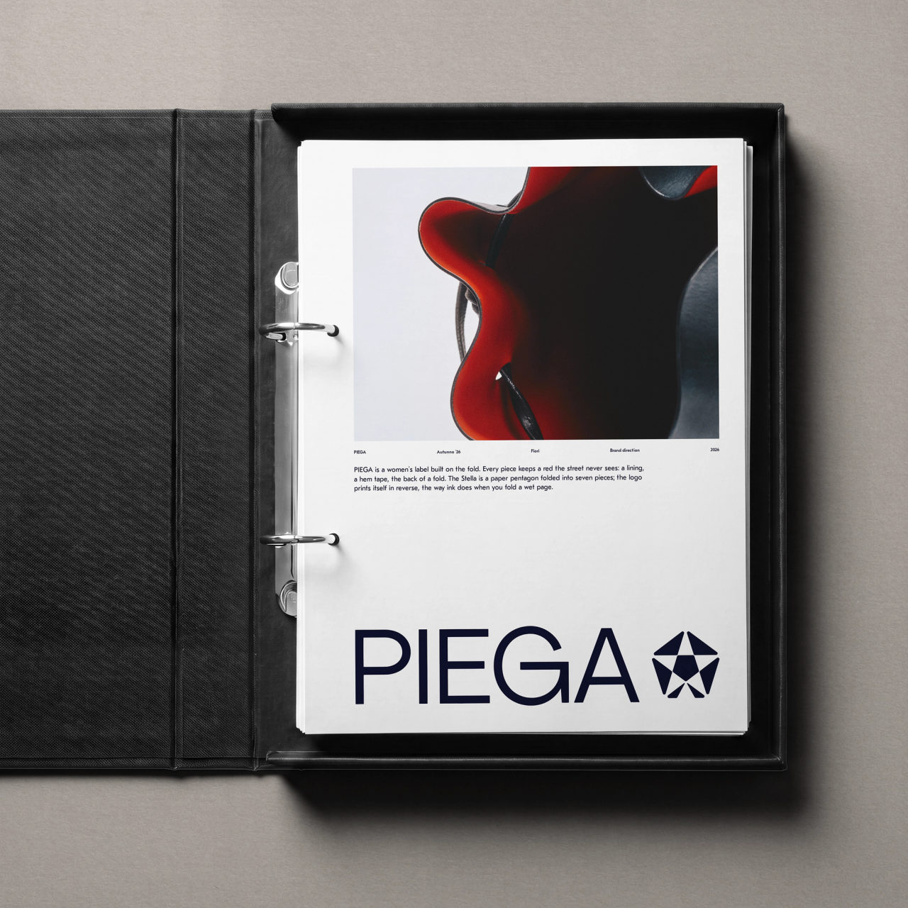 PIEGA brand page with a red close-up and large wordmark in a black binder