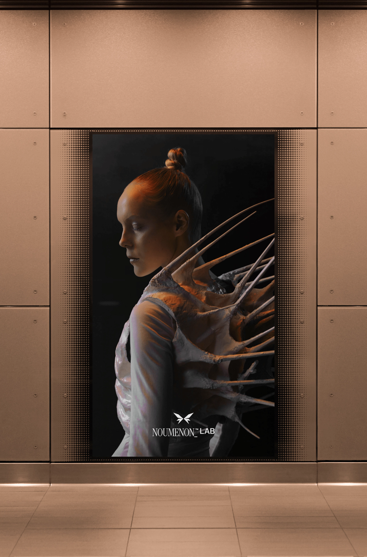 A woman in a spiked sculptural garment on a NOUMENON LAB poster in a metal-panelled wall