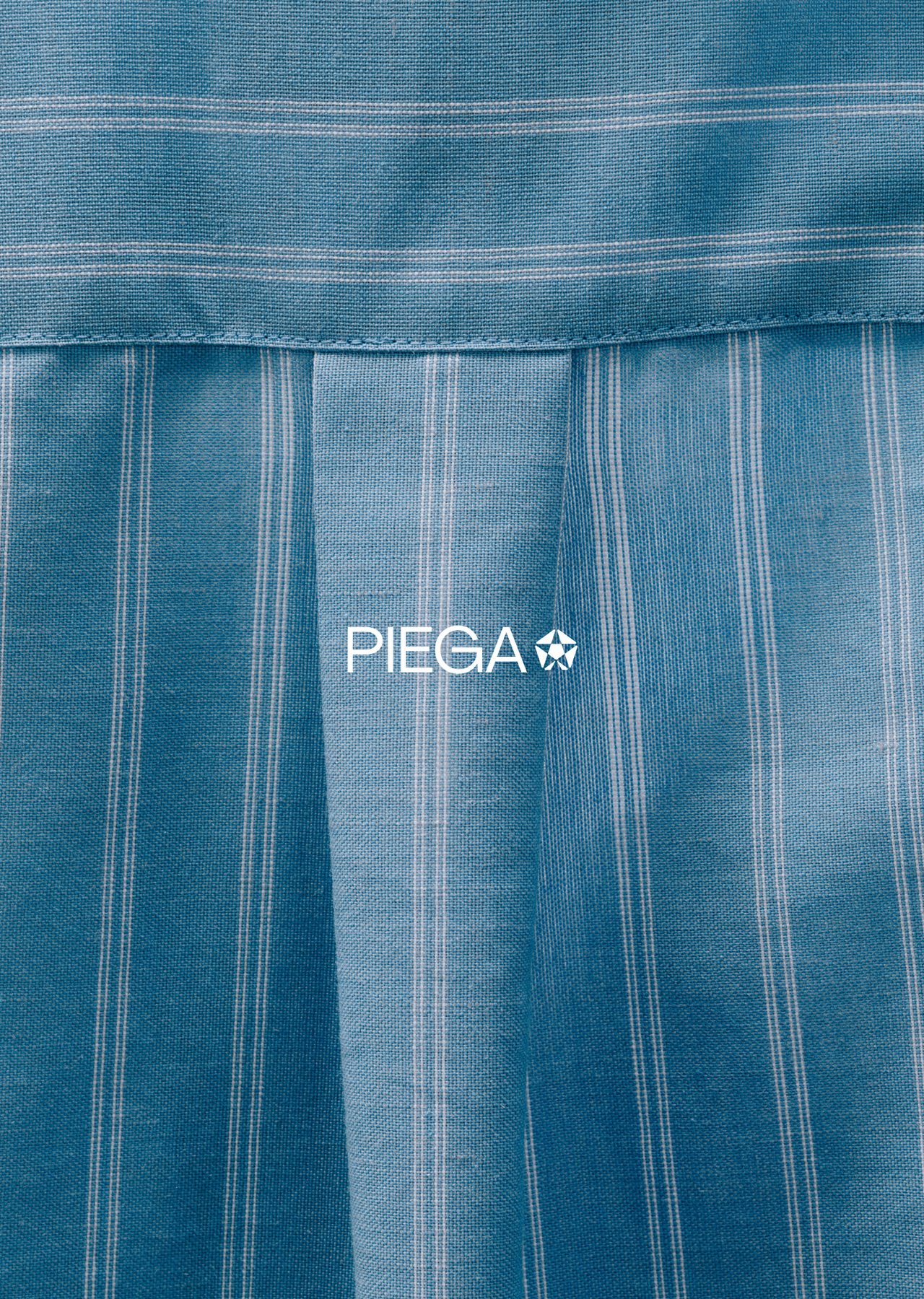 Pleated blue pinstripe fabric with the PIEGA wordmark in white