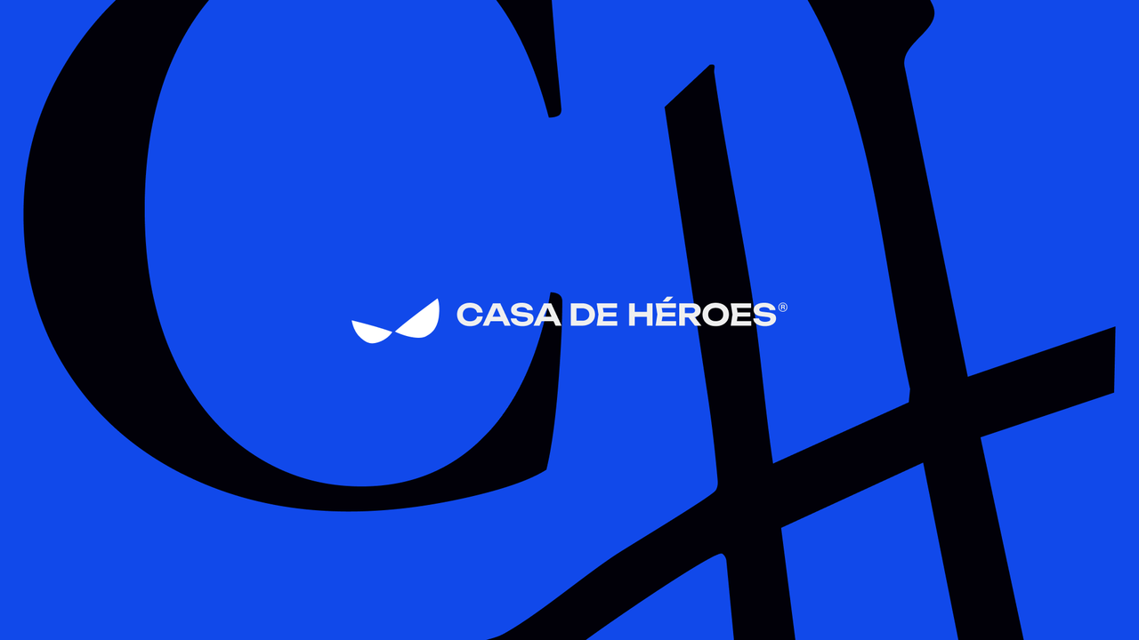 Horizontal Casa de Héroes logo in white over a giant black CH monogram on blue