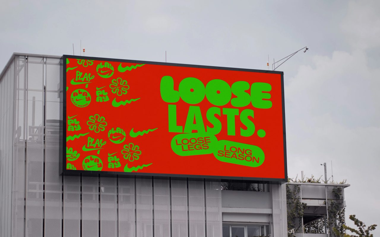 Rooftop billboard reading Loose Lasts in green on red, with Nike Play logos at left
