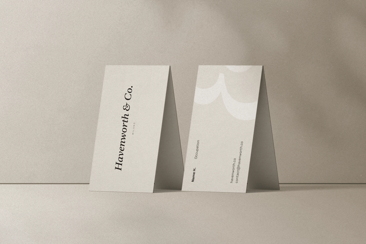 Front and back of a Havenworth & Co. business card propped on beige