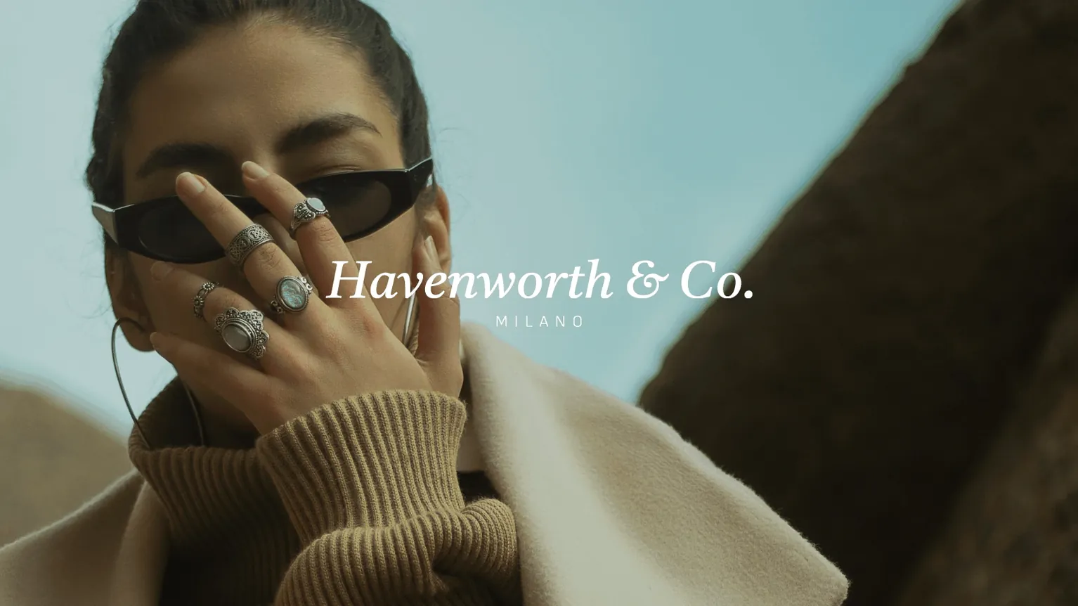 A woman in sunglasses and rings beside the Havenworth & Co. wordmark