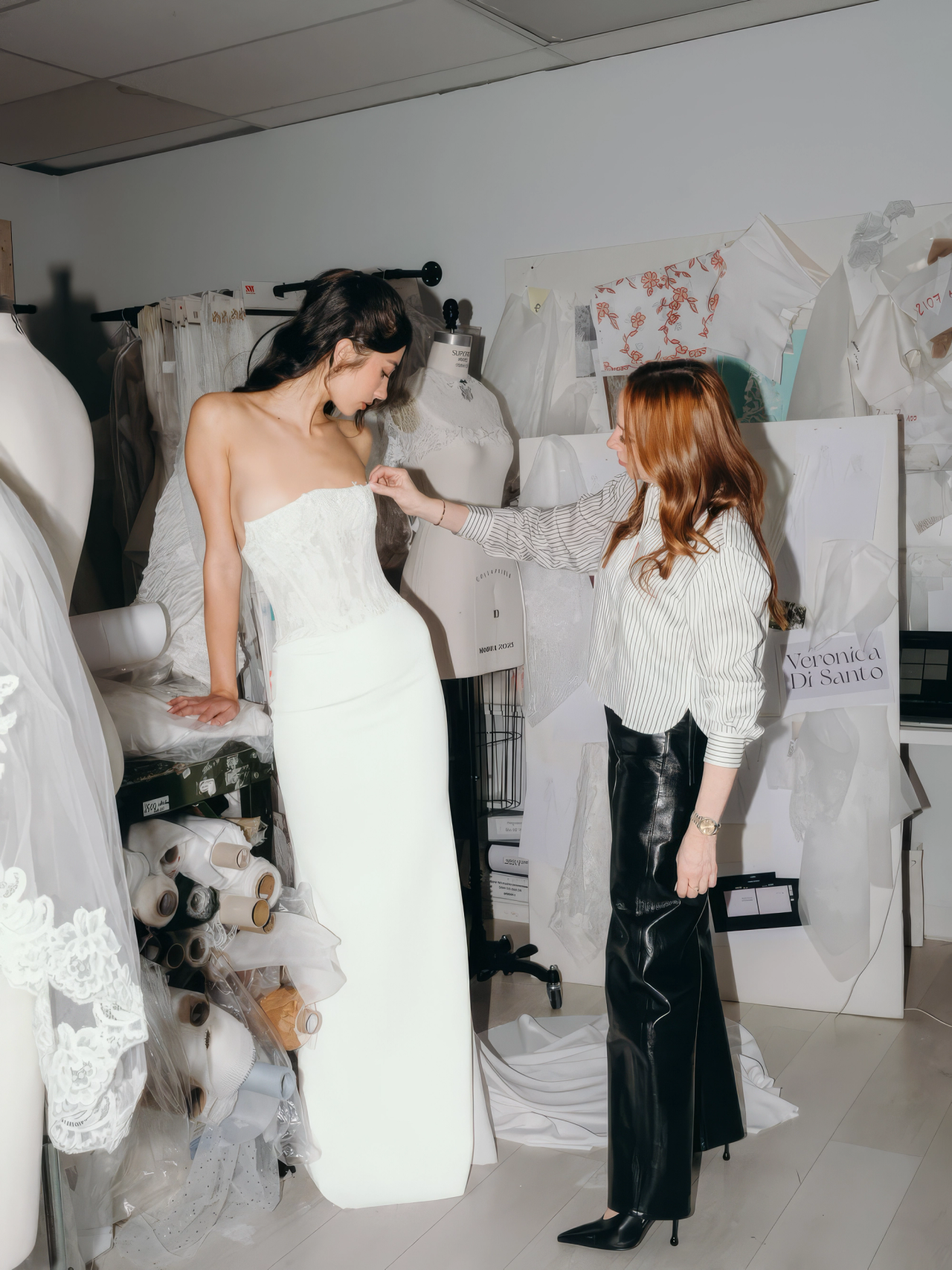 A bride at a fitting in the atelier
