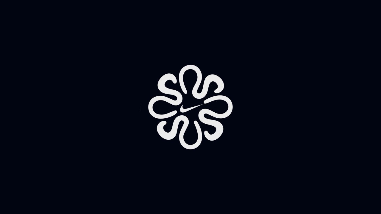 Nike Play flower mark, white loops around a small swoosh, on a near-black field