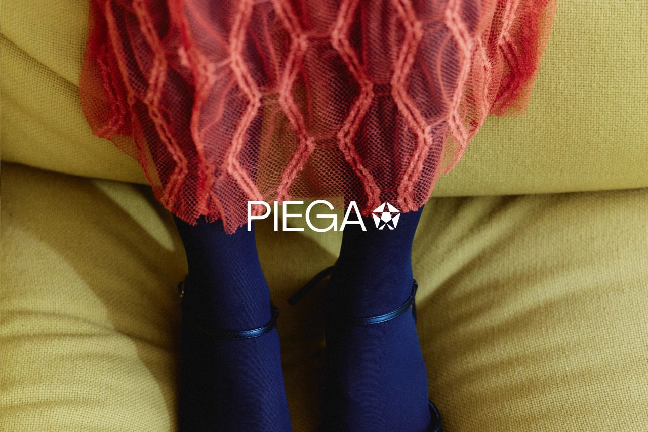 Red lace and blue tights under the PIEGA wordmark