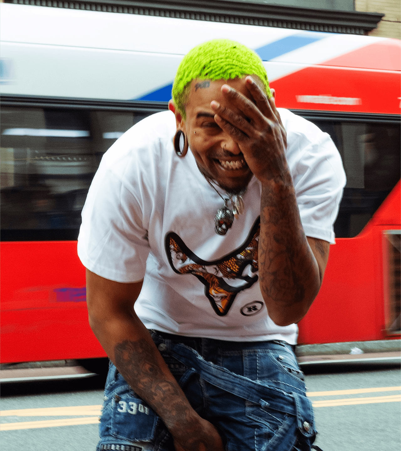 A man with green hair in a Destroy 2 Rebuild tee