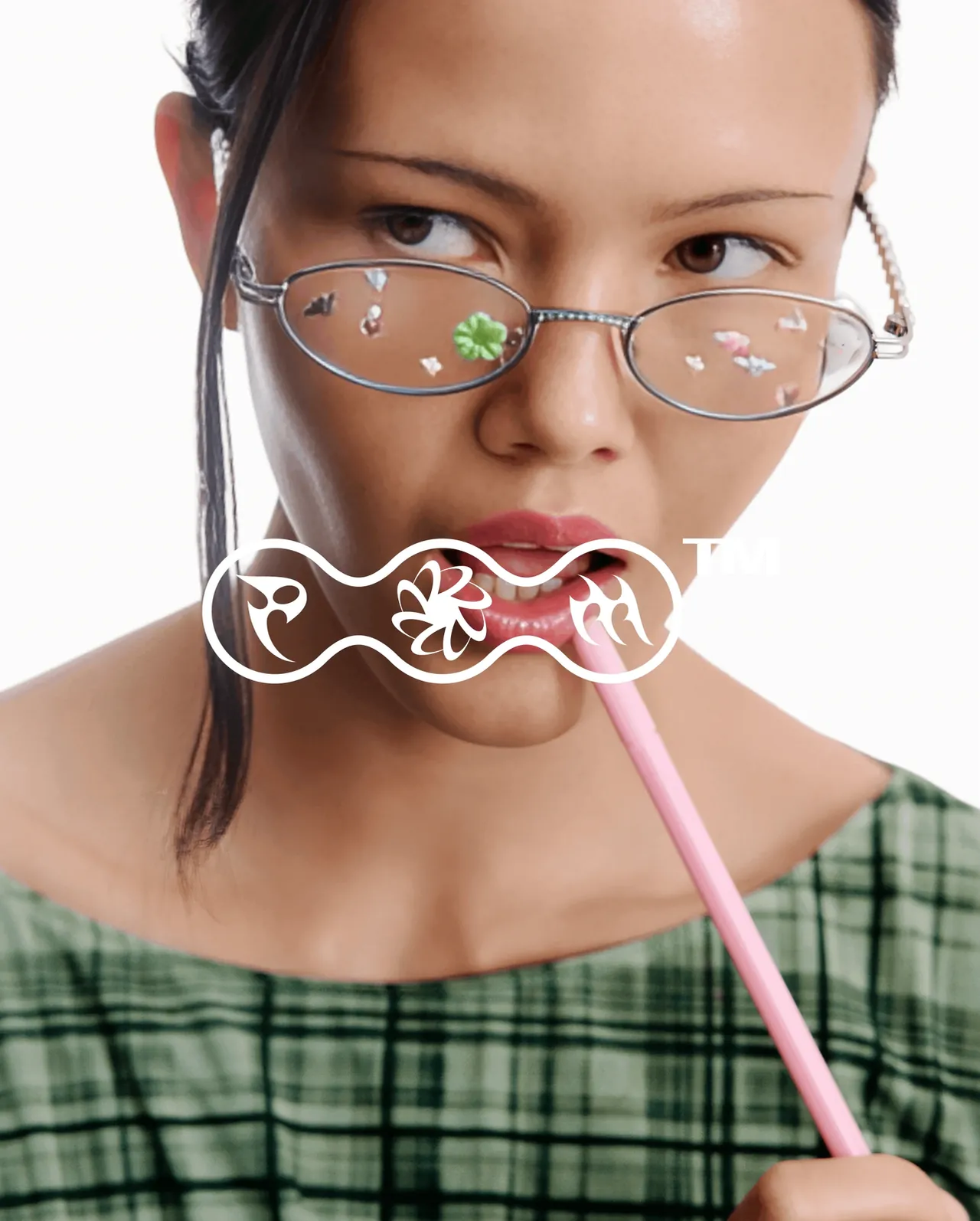 A woman in charm-dotted glasses biting a pink stick behind the PORTO MORTO mark