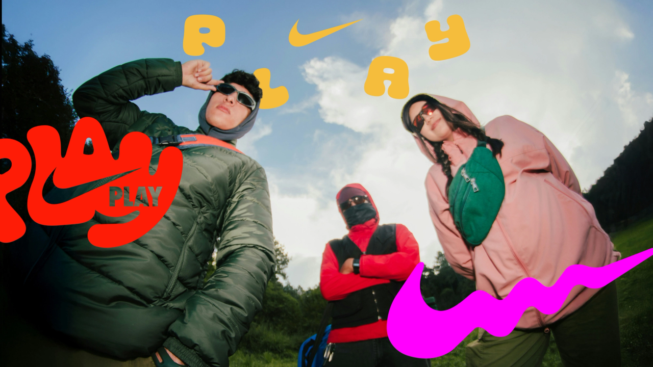 Friends in outdoor gear on a hillside, shot fisheye, with PLAY lettering