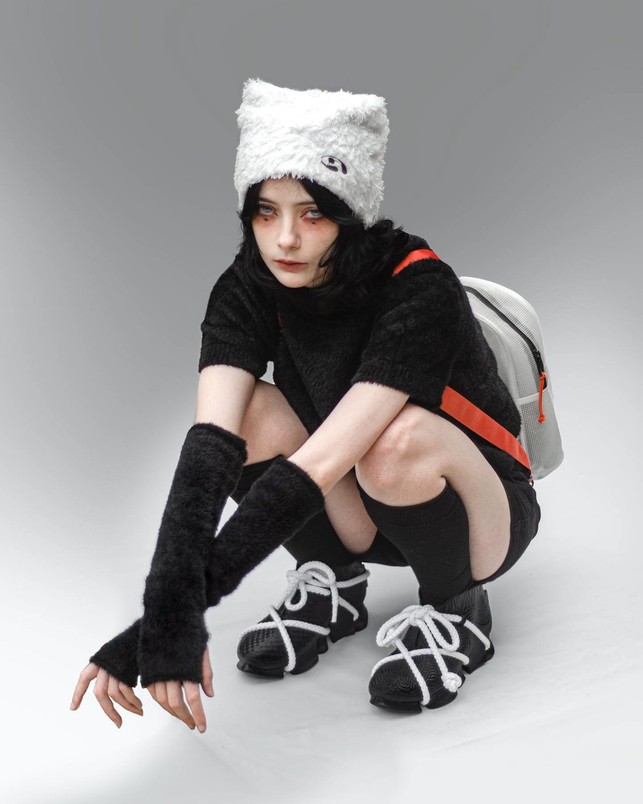 A model crouching in 3D-printed shoes