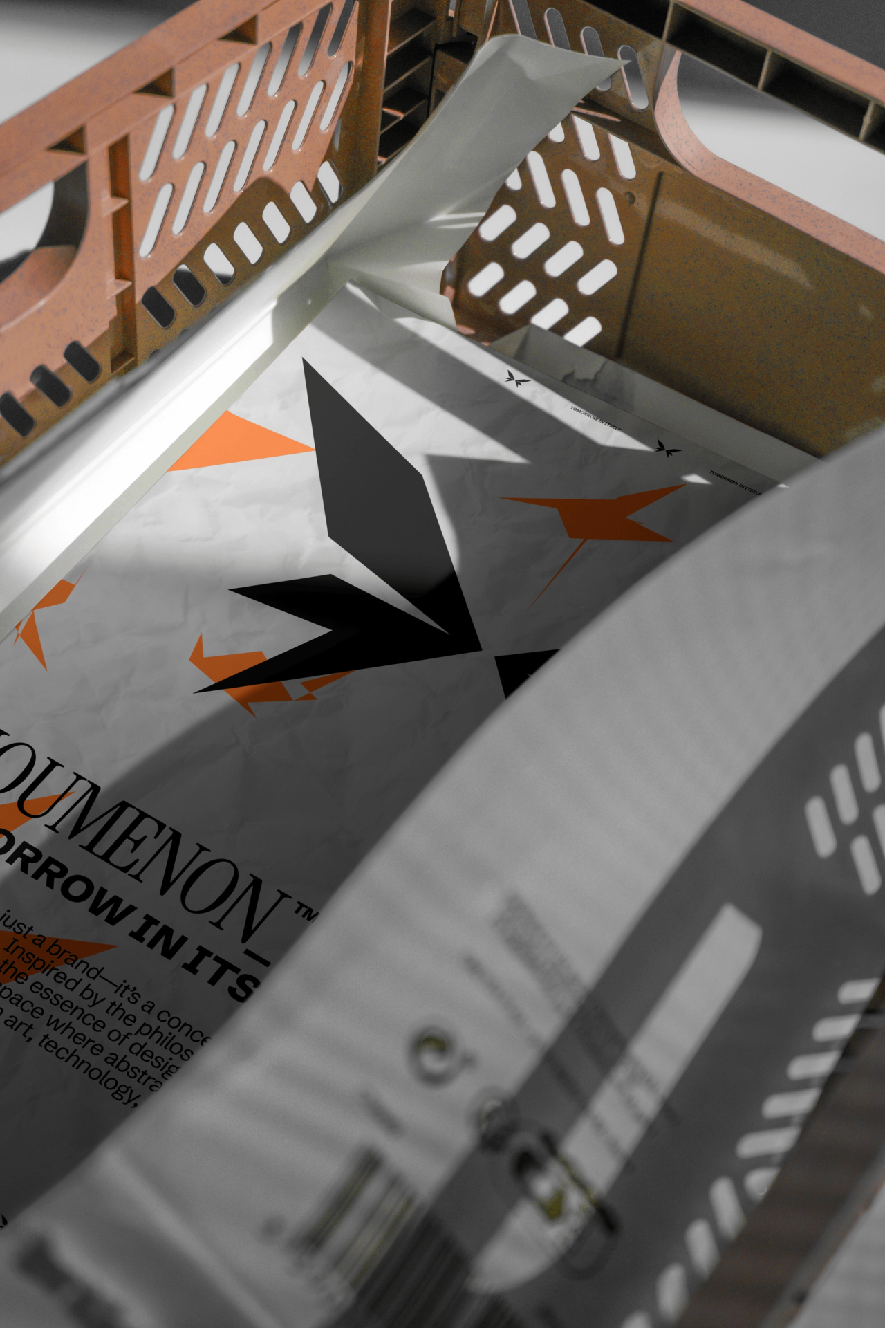 Crinkled NOUMENON LAB print with a black butterfly symbol and orange shards in a slotted crate