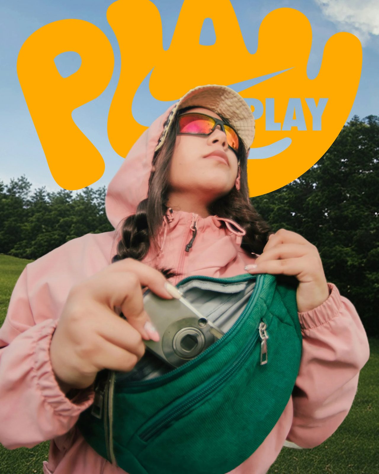 A woman in a pink hooded jacket under PLAY lettering