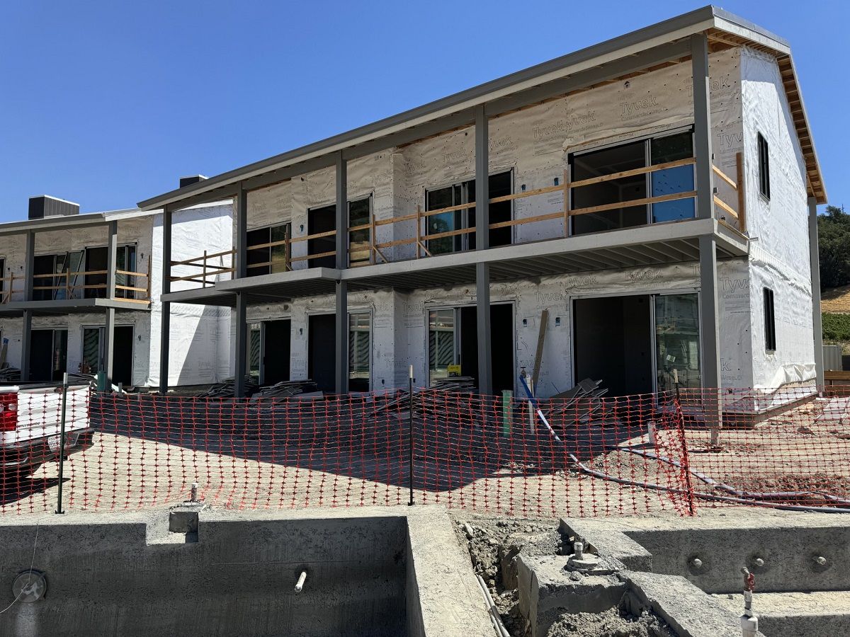 Large sheets of Tyvek wrapped around the outer structures of the buildings