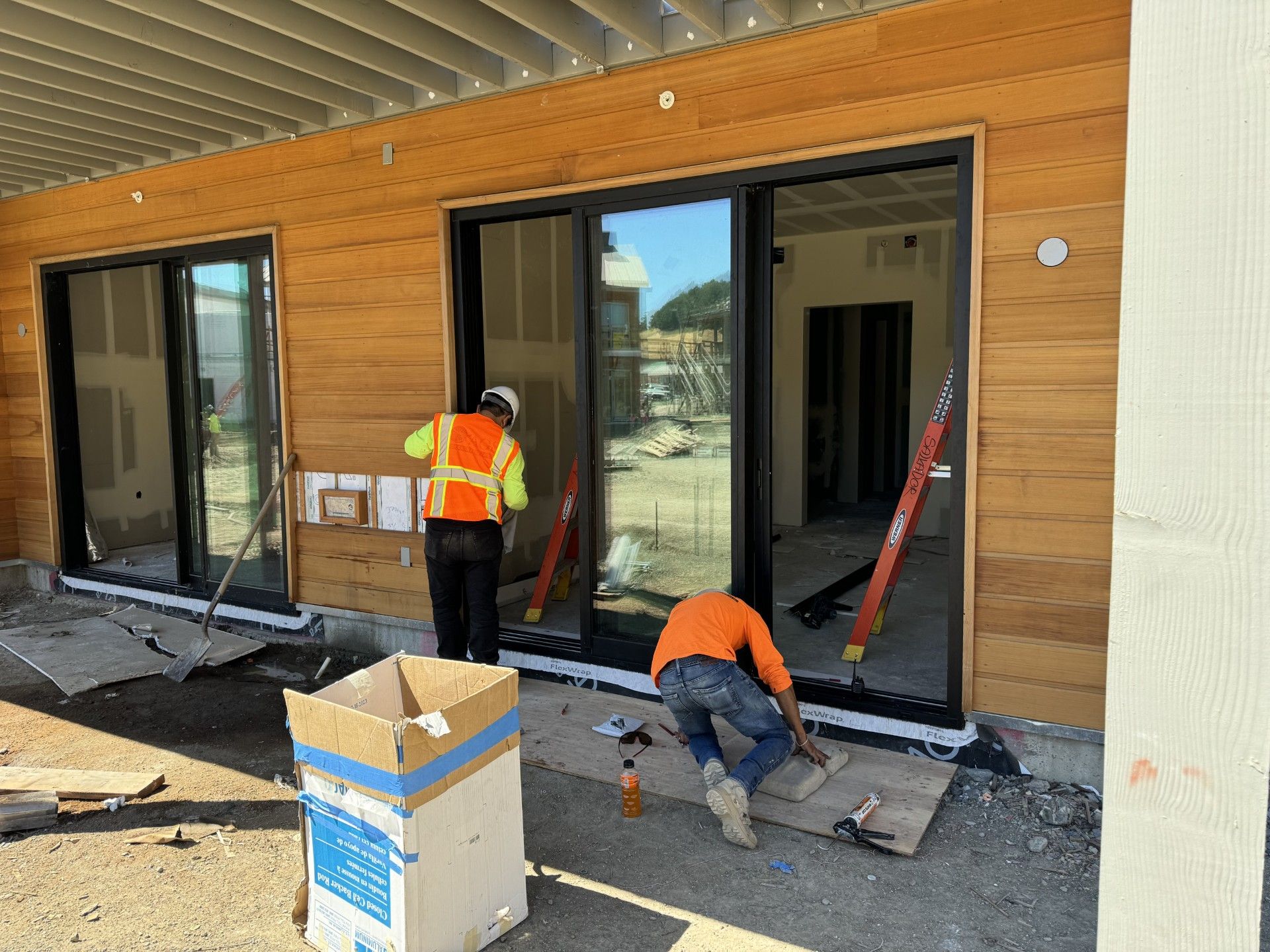 Subcontractors installing sliding doors