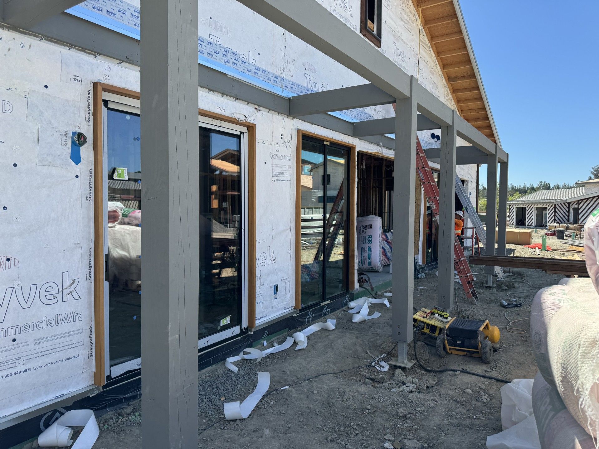 Sliding doors installation and Tyvek siding applied to exterior walls