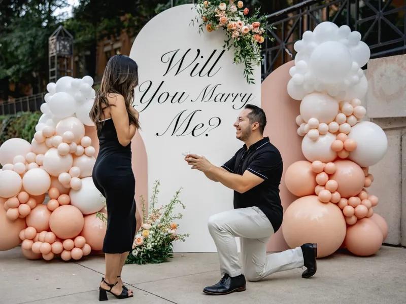 Balloon proposal setup with a Will You Marry Me sign in Chicago