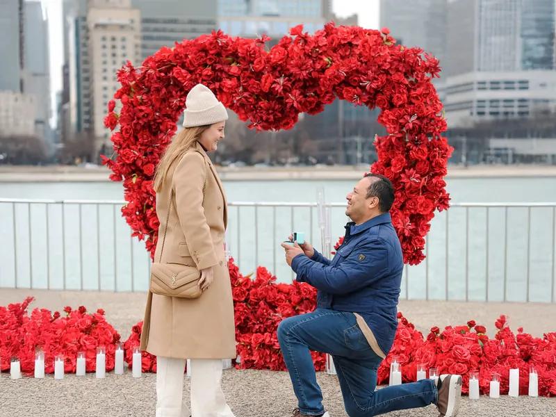 Red flower arch proposal setup on the Chicago lakefront