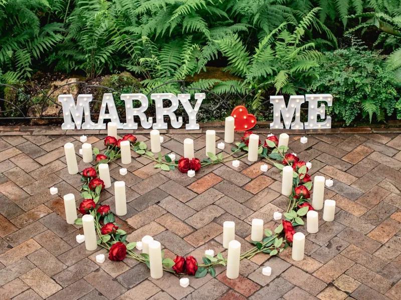 Marry Me letters with a candle and rose heart in Chicago