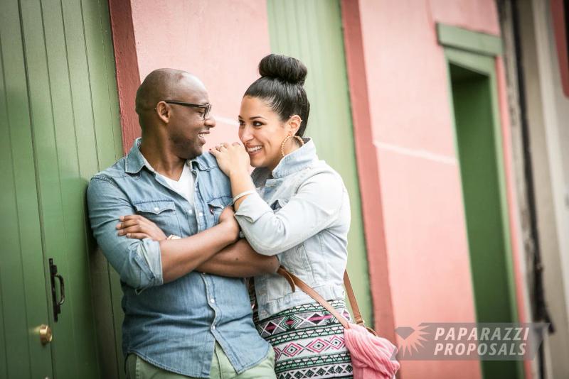Christian and Sofia laughing together against a pastel wall