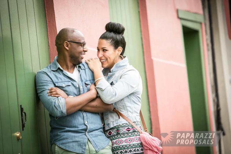 Christian and Sofia laughing together against a pastel wall