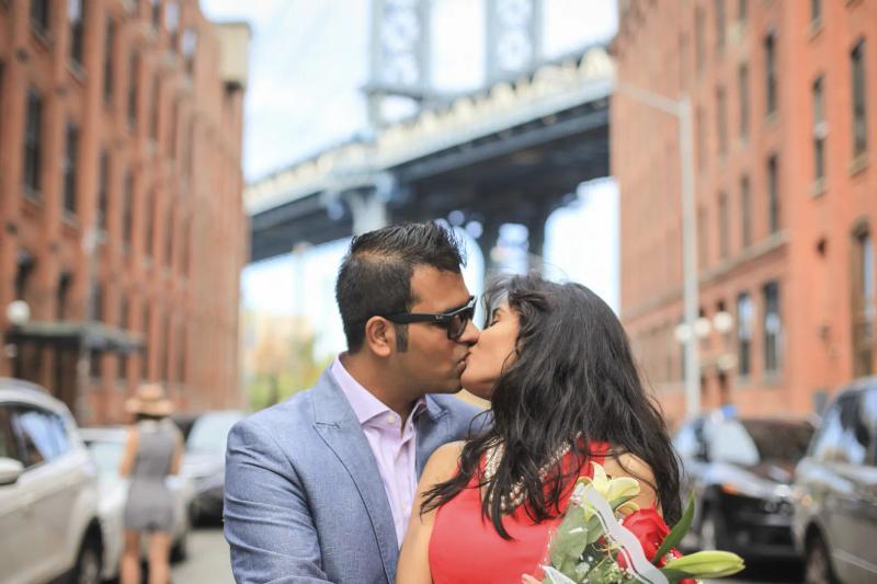 Mukul and Asha kissing after the proposal with a bridge behind them