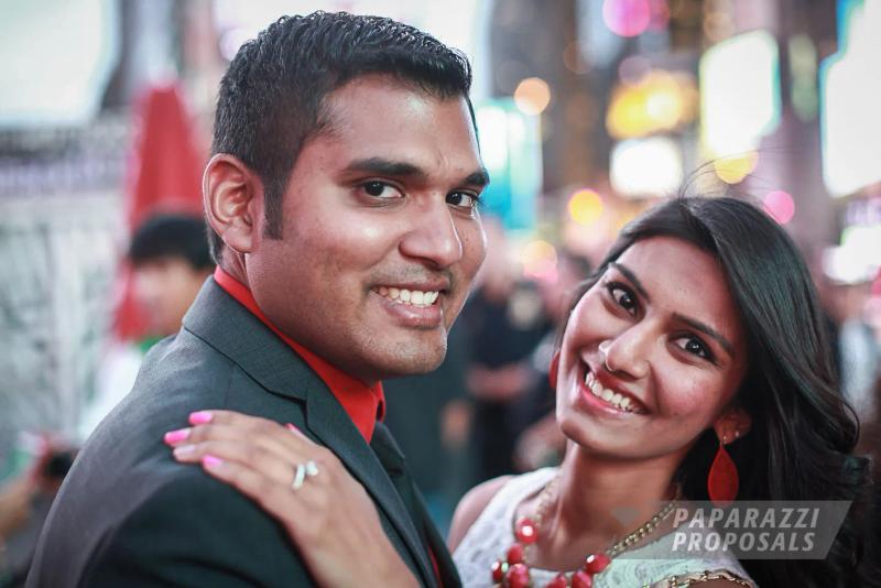 Vishal and Pavita smiling together after their proposal, city lights behind them