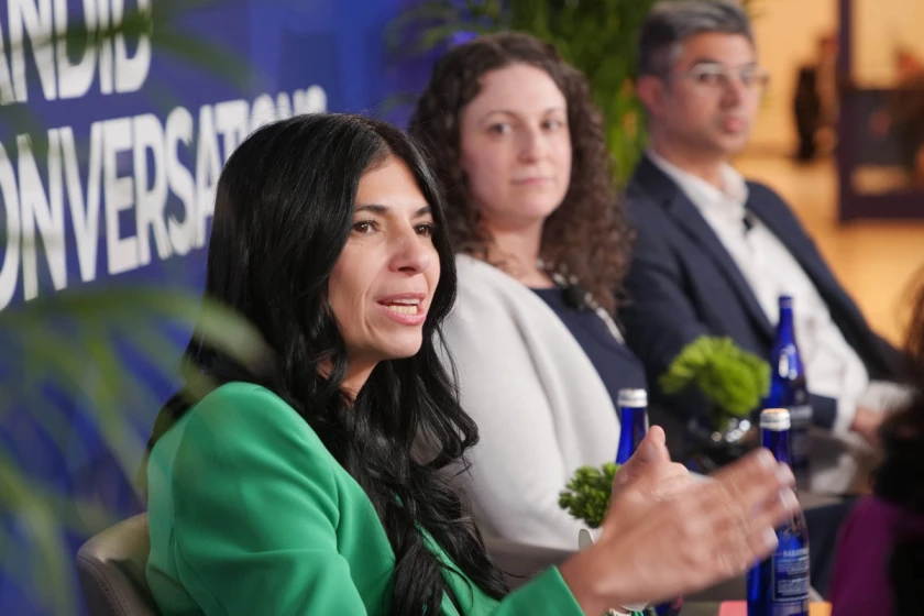 Panel discussion at a healthcare conference highlighting collaboration and team-based care in point-of-care marketing.