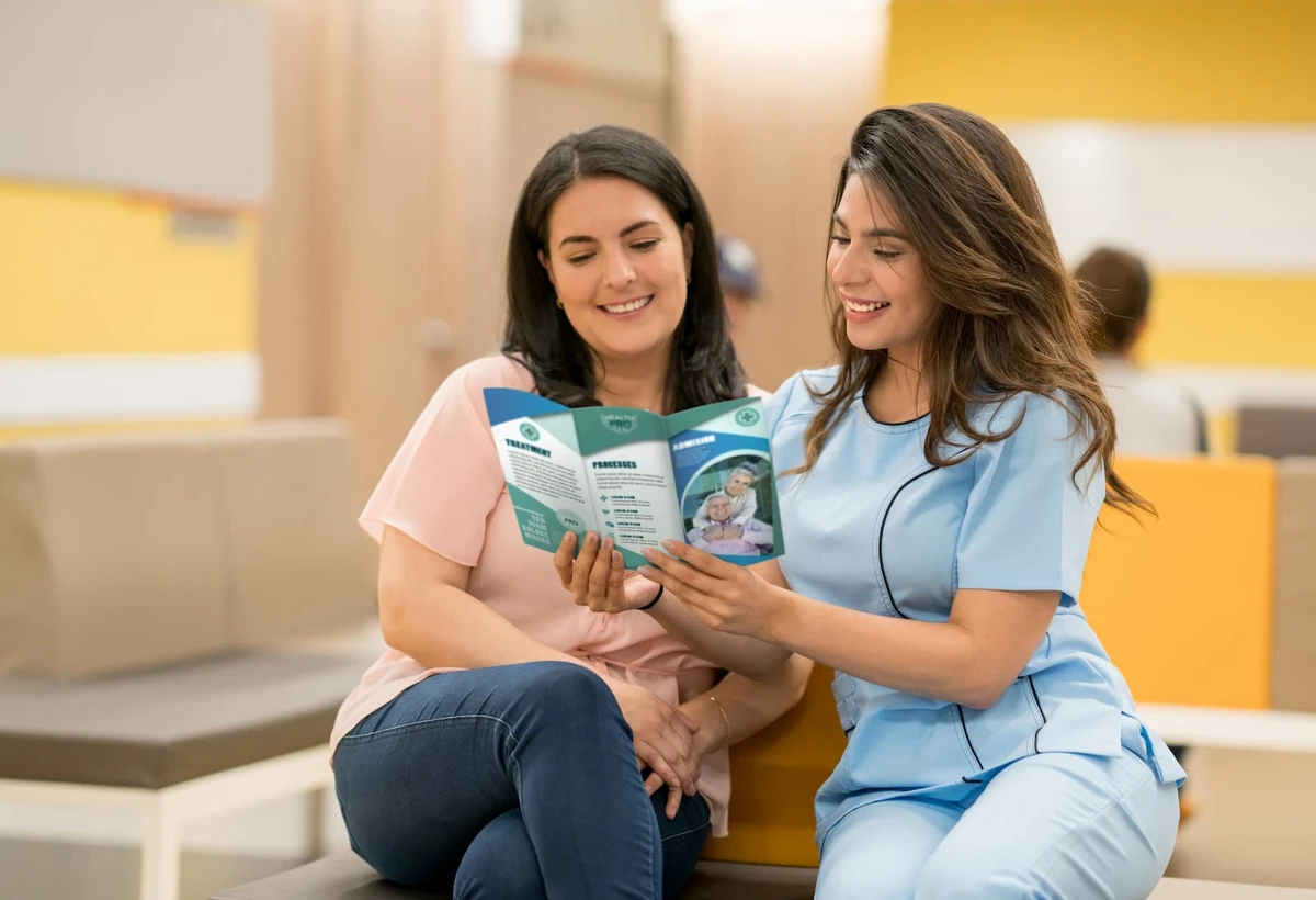 Nurse sharing an educational brochure with a patient in a waiting room
