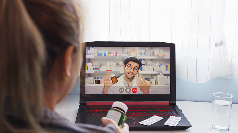 Patient on a video call with a pharmacist on a laptop