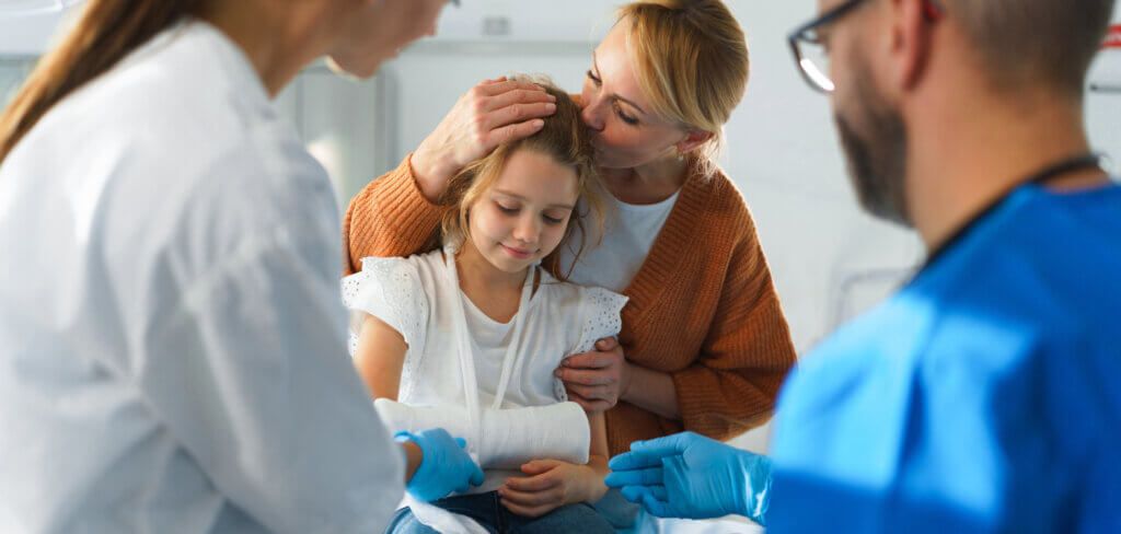 Doctor giving care to a little girl in an emergency room