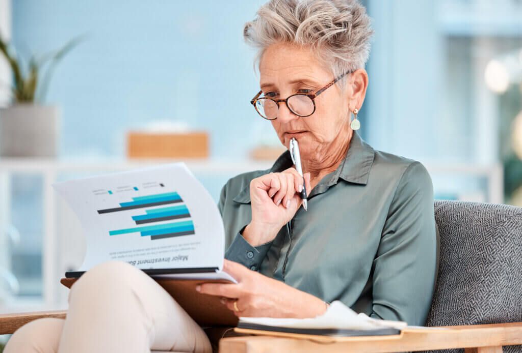 Healthcare Marketing report, data and business woman planning company budget, economy growth on paper and thinking of investment analytics. Corporate accounting, financial strategy and accountant with research.