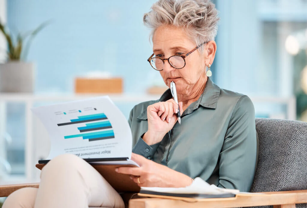 Healthcare Marketing report, data and business woman planning company budget, economy growth on paper and thinking of investment analytics. Corporate accounting, financial strategy and accountant with research.