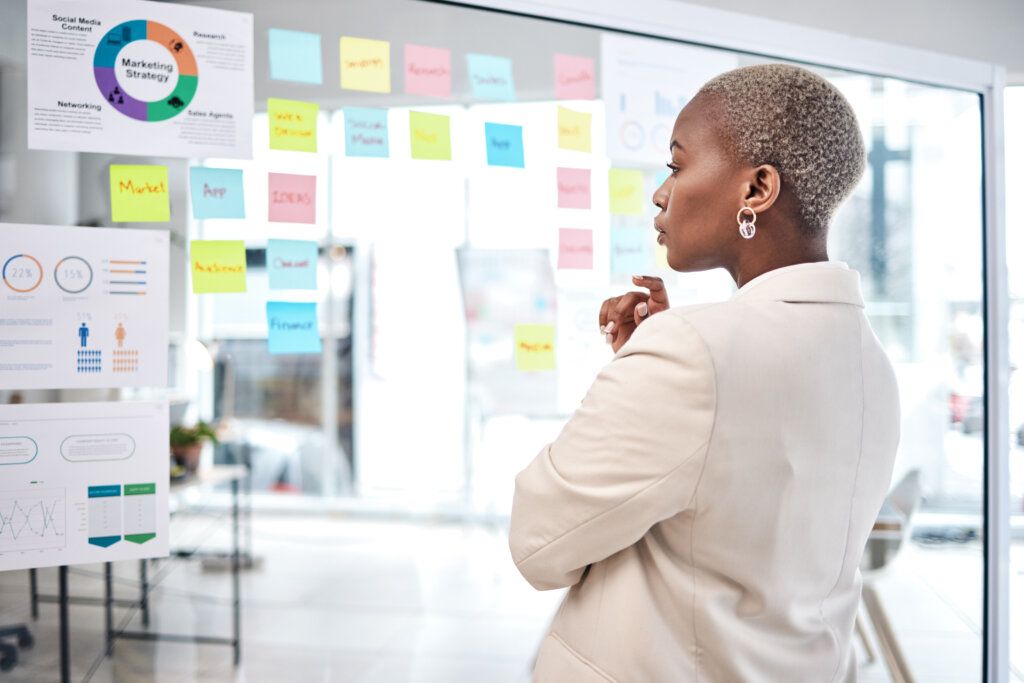 African American woman looking at marketing metrics reporting